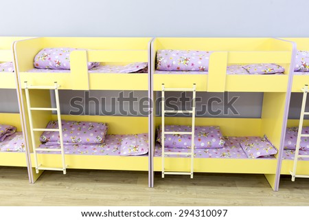 Sofia, Bulgaria - June 9, 2015: Modern kindergarten bedroom with small bunk beds with stairs for the kids.