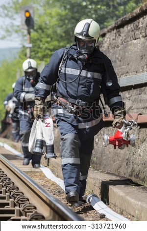 Sofia, Bulgaria - May 19, 2015: Firefighters are approaching a chemical cargo train crash near Sofia, Bulgaria. Teams from Fire department are participating in a training with spilled toxic materials.