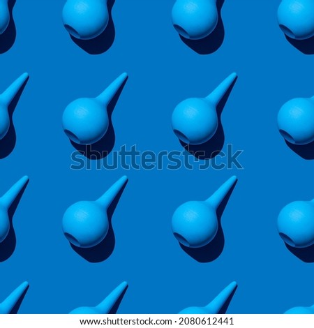 A seamless pattern of multiple blue medical enema. Photographed with hard light (sharp black shadows). Professional clinical aspirator made of rubber. Mucus suction tool. Photo stock © 