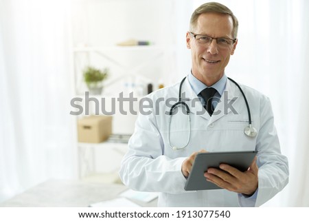Similar – Image, Stock Photo doctor man indoors, using mobile phone. Wearing protective gloves, mask and stethoscope. coronavirus covid-19 concept