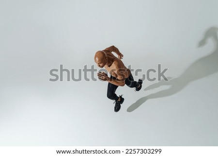 Similar – Image, Stock Photo Top view athlete runner training at road in black sportswear.