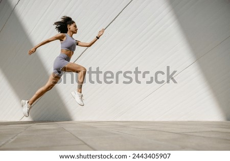 Similar – Image, Stock Photo young fit woman running away doing sport on a path in park