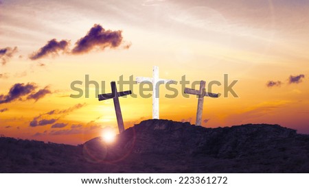 An impression of the three crosses on the mountain golgotha representing the day of christs crucifixion in a sunset.