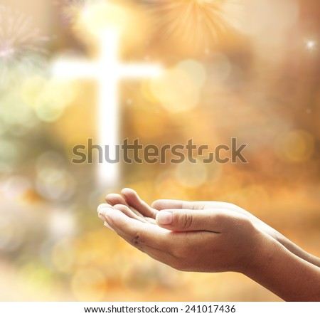 Human open empty hands with palms up, over blurred the cross with fireworks on night background.