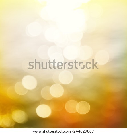 Abstract Blurred colorful booked clear sea water reflecting in the sun over beautiful sunset background.