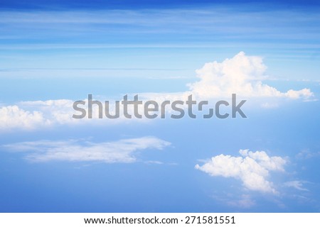 White clouds over blue ocean as seen through window of an aircraft. World oceans day concept.