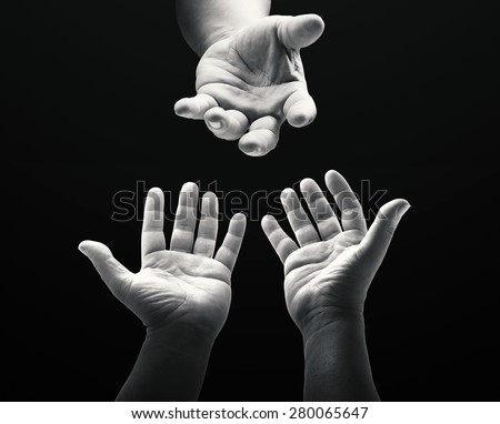 Black and white human hands or Adam's hand reaching to hand of God over black  background. Pray for support concept. International Day for the Eradication  of Poverty concept. - Stock Image - Everypixel