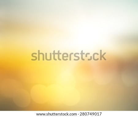 Blurred nature background. Sandy beach backdrop with turquoise water and bright sun light. Summer holidays concept.