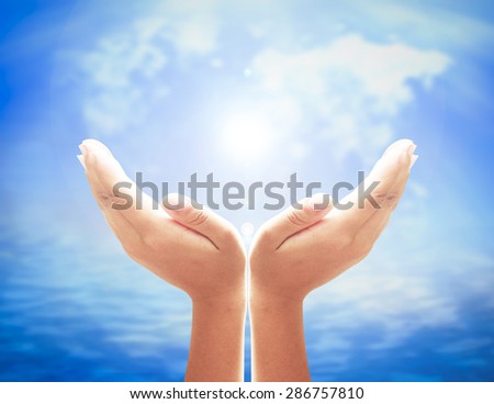 Human open empty hands with palms up over blurred white world map of clouds on blue sky and beautiful oceans background. Environment concept. Pray for support concept.
