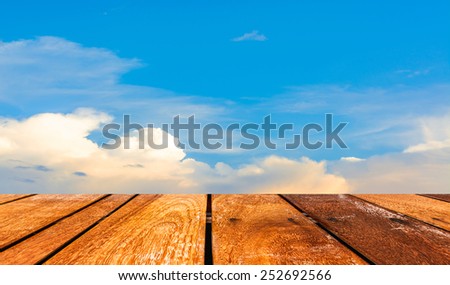 image of clear sky and white clouds on day time with wood table