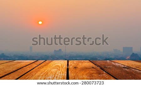 Hazy skyline of Chiang Mai City ,Thailand smog covering buildings with sunrise .