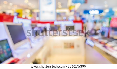 blur image of eletronic department store with bokeh for background usage .