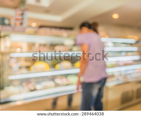 Blur image of people in bakery shop for background usage .
