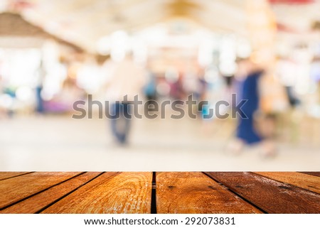 Blurred image of people walking at day market , blur background with bokeh.