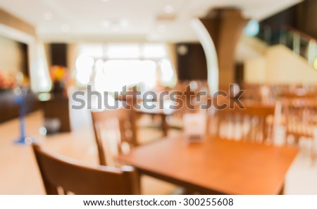 image of blur empty catering room with table set on day time for background usage .