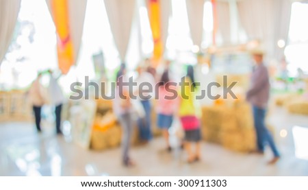 blurred image of shopping mall and people for background usage .