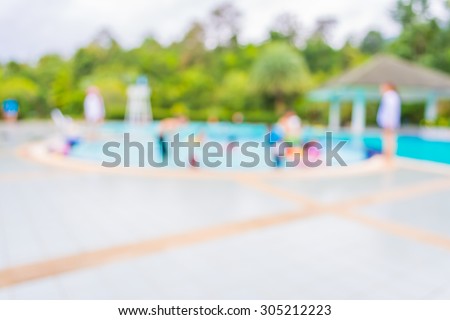 image of blur people at swimming pool with bokeh for background usage .