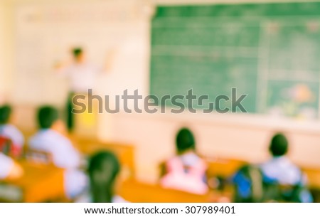 vintage tone image of blur kids and teacher in the classroom for background usage.