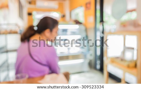 image of blur people at bakery shop with bokeh for background usage .