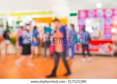 blurred image of people at shopping mall for background usage .