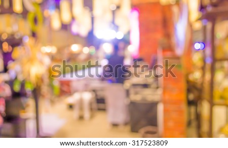 blurred image of people at trade show for background usage .