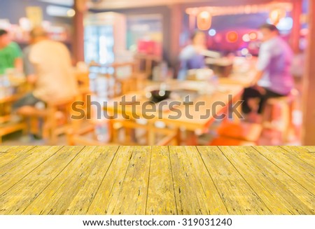 Empty top surface old yellow wooden table and Blurred background image of  Customer at japan restaurant blur background with bokeh