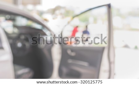 blur image of Commercially cars stand in show room of car shop.