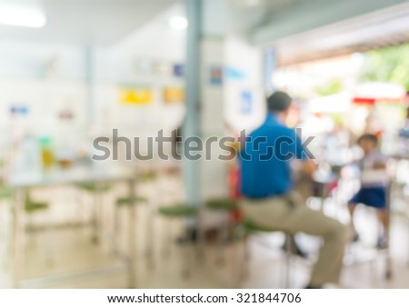 image of blur people at food stall with bokeh for background usage .