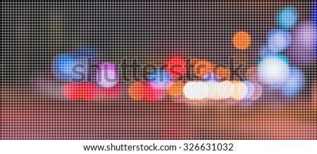 image of blur street with warm colorful lights in night time for background usage .(dot Pattern Pixelation effect image)