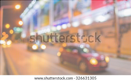 image of blur street and billboard with warm colorful lights in night time for background usage .(dot Pattern Pixelation effect image)