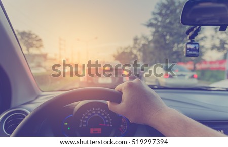 vintage tone image of people driving car on day time for background usage.(take photo from inside focus on driver hand) Foto stock © 