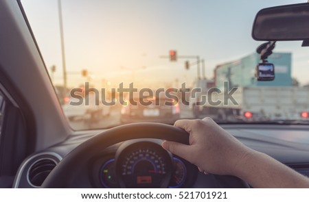 vintage tone image of people driving car on day time for background usage.(take photo from inside focus on driver hand) ストックフォト © 