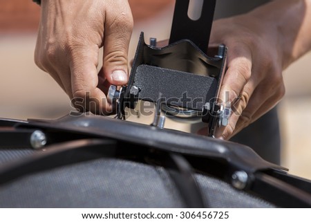 Engineer tightening nut onto a screw bolt using hands