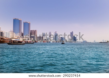 DUBAI, UAE - MARCH 30, 2015: Panoramic view of Deira Twin Towers from Dubai Creek. The Deira Twin Towers are multi-use buildings and contain a shopping center, residential and office towers.