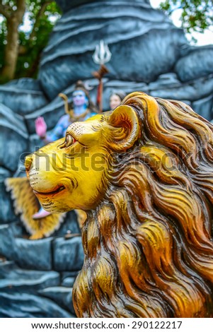 ORRISA, INDIA - APRIL 26, 2015: Lion statue in front of the Lord Shiva statue sitting with with goddess Parvati in Orrisa, India