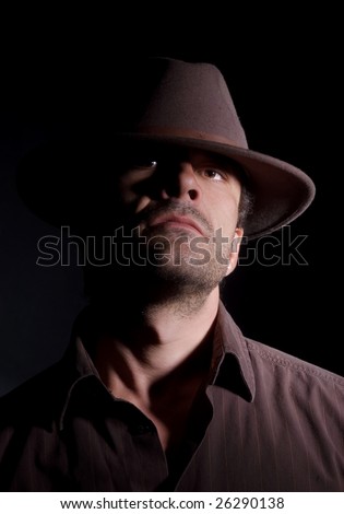 Handsome male wearing a hat; has a somewhat arrogant/intimidating look