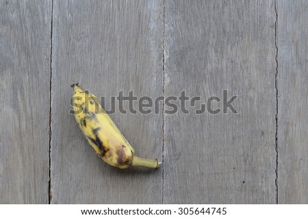 one banana rotten on  wood ground