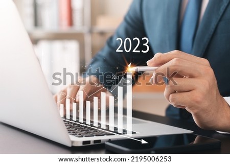 Businessman analyzes profitability of working companies with digital augmented reality graphics, positive indicators in 2023, businessman calculates financial data for long-term investments. Stock fotó © 