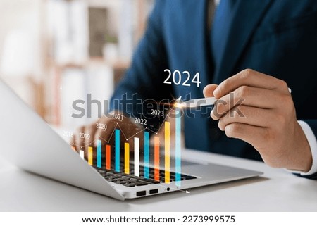 Businessman analyzes profitability of working companies with digital augmented reality graphics, positive indicators in 2024, businessman calculates financial data for long-term investments. Stock fotó © 