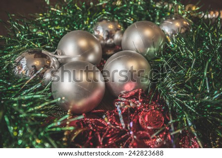 ball silver silvery present spruce fir Christmas toy tinsel red purple golden gold wooden floor