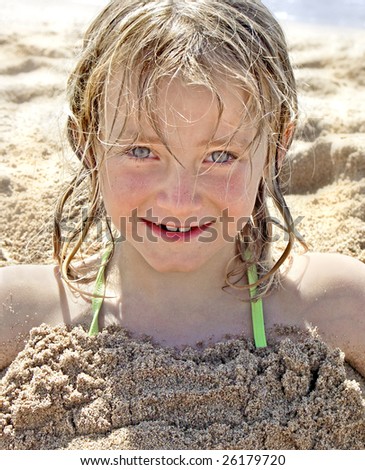 Portrait Of Cute Little Girl On The Beach, Buried Up To Her Neck In ...