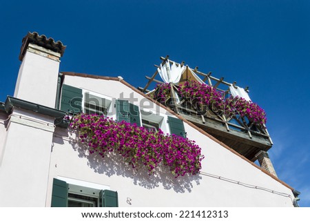 House Facade with balconies full of flowers in Torcello ,Venice, Italy