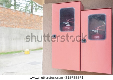 Two fire extinguishers in their lockers red. Copy space