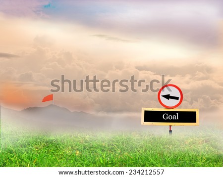 Signs pointing the way to the flag of success and background lawn, mountain, sky.
