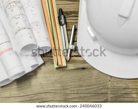 Architectural blueprint of office building with a pencil on wood table
