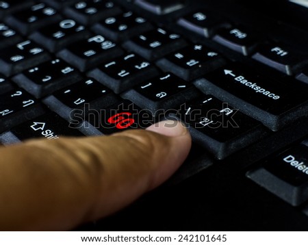 black finger typing messages go red button on computer black keyboard.