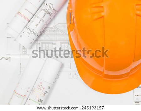 Architectural blueprint of office building with a pencils and Helmet Safety
