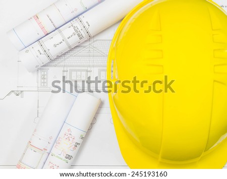 Architectural blueprint of office building with a pencils and Helmet Safety