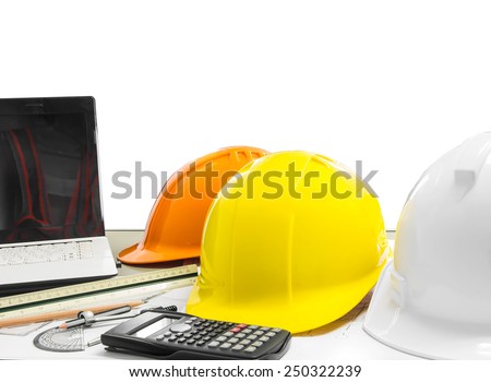 Architectural blueprint of office building with safety helmet , stationery , notebook