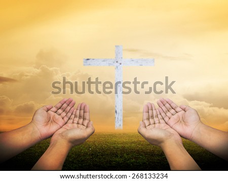 Human open empty hands with palms up, over the blurred white cross